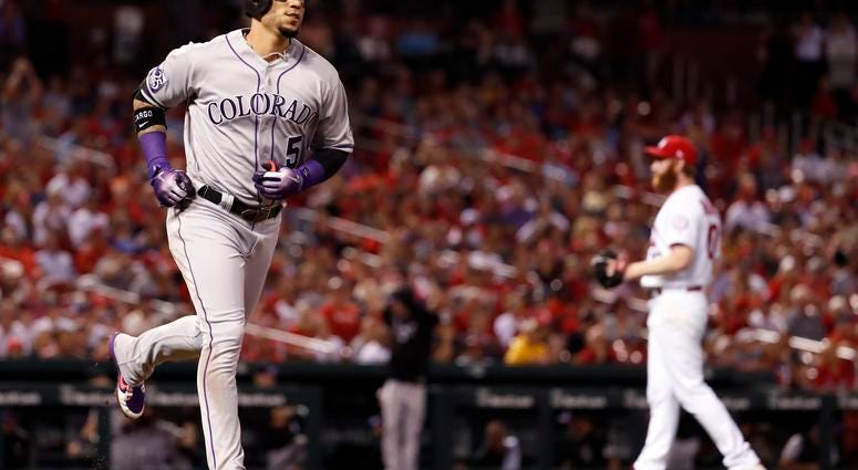 Colorado Rockies' Carlos Gonzalez, left, rounds the bases after hitting a two-run home run off St. Louis Cardinals relief pitcher John Brebbia during the seventh inning of a baseball game Tuesday, July 31, 2018, in St. Louis. Colorado Rockies' Carlos Gonzalez, left, rounds the bases after hitting a two-run home run off St. Louis Cardinals relief pitcher John Brebbia during the seventh inning of a baseball game Tuesday, July 31, 2018, in St. Louis.